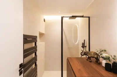 a room with a glass door and a statue on a wooden table at Quartier Marriott - Superbe 3 pieces in Cannes