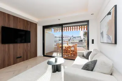 a living room with a white couch and a large window at Quartier Marriott - Superbe 3 pieces in Cannes