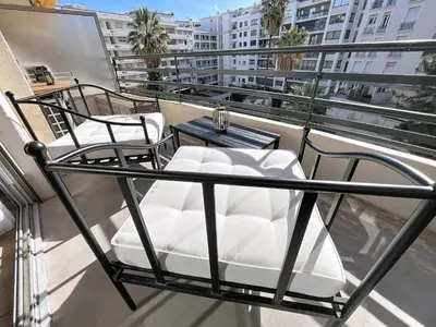 a balcony with two chairs and a table at Beautifull studio with balcony Rouaze Miramar 120 in Cannes