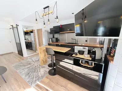 a kitchen with a table and a counter top at Beautifull studio with balcony Rouaze Miramar 120 in Cannes
