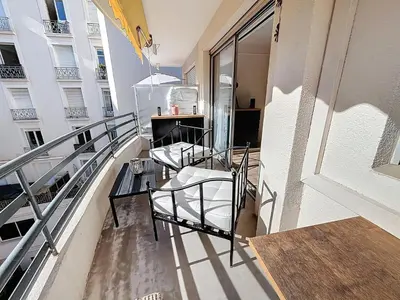 a balcony with chairs and a table on a building at Beautifull studio with balcony Rouaze Miramar 120 in Cannes