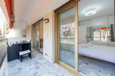 a bedroom with a large glass window and a bed at 1-Br Near the Croisette and City Centre in Cannes