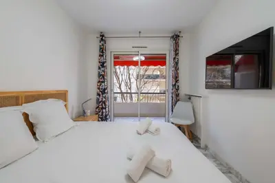 a bedroom with a white bed with two towels on it at 1-Br Near the Croisette and City Centre in Cannes