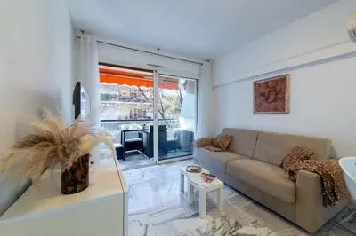 a living room with a couch and a table at 1-Br Near the Croisette and City Centre in Cannes