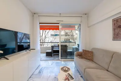 a living room with a couch and a tv at 1-Br Near the Croisette and City Centre in Cannes