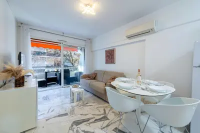 a living room with a table and a couch at 1-Br Near the Croisette and City Centre in Cannes