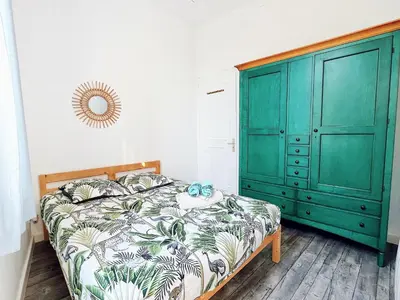 a bedroom with a green cabinet and a bed at 2 Bedrooms Apartment-Cannes Center Suquet-2mins to Beach & 10mins to Palais-AirConditioning & FiberWifi in Cannes