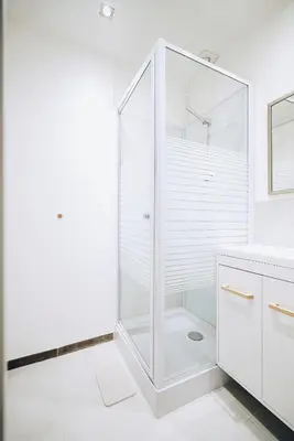 a white bathroom with a shower and a sink at 2 Bedrooms Apartment-Cannes Center Suquet-2mins to Beach & 10mins to Palais-AirConditioning & FiberWifi in Cannes