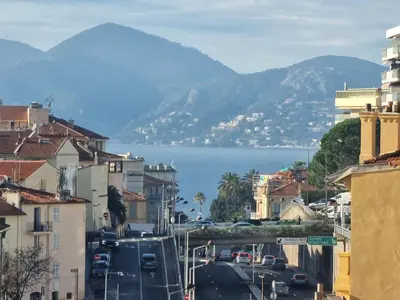 a city street with a view of the water and mountains at 69m2, balcon vue mer, 2 salles de bain in Cannes