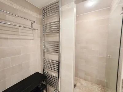 a bathroom with a walk in shower next to a toilet at 86m2, spacieux, 2 chambres, à 1 min de la plage in Cannes