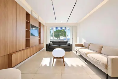 a living room with a couch and a table at Celestre Croisette - Appartement de Luxe Croisette avec Terrasse et Vue Mer in Cannes