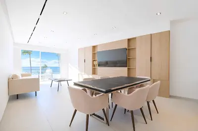 a dining room with a table and chairs at Sable Croisette - Appartement de Luxe avec terrasse et vue Mer in Cannes