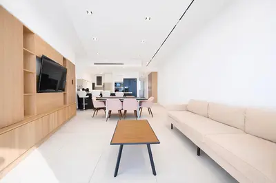 a living room with a couch and a table at Sable Croisette - Appartement de Luxe avec terrasse et vue Mer in Cannes