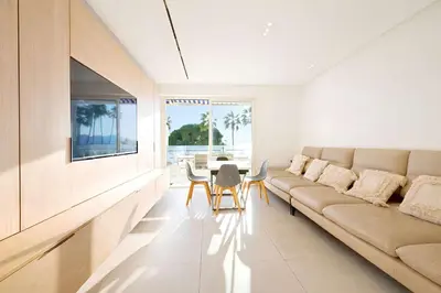 a living room with a couch and a table at Prestige Croisette - Apartment with Panoramic Terrace and Sea View in Cannes in Cannes