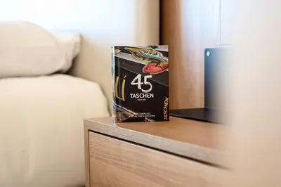a bag of pasta sitting on a table next to a bed at Prestige Croisette - Apartment with Panoramic Terrace and Sea View in Cannes in Cannes