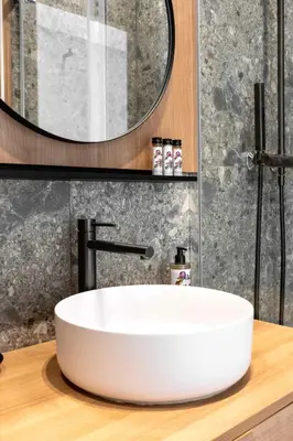 a bathroom with a white sink and a mirror at Prestige Croisette - Apartment with Panoramic Terrace and Sea View in Cannes in Cannes