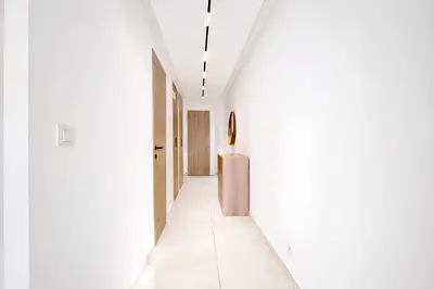 a hallway of a house with white walls and white floors at Prestige Croisette - Apartment with Panoramic Terrace and Sea View in Cannes in Cannes