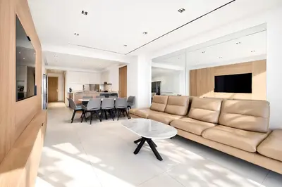 a living room with a couch and a table at Reflet Croisette - Luxury Apartment with Terrace and Sea View in Cannes