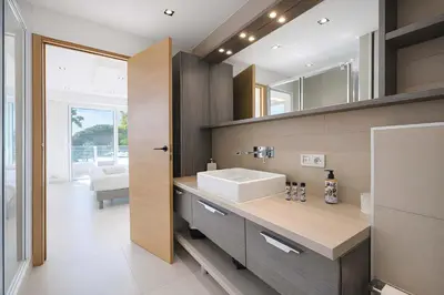 a bathroom with a sink and a mirror at Reflet Croisette - Luxury Apartment with Terrace and Sea View in Cannes