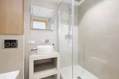 a bathroom with a sink and a shower at Reflet Croisette - Luxury Apartment with Terrace and Sea View in Cannes