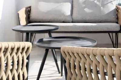 a living room with two tables and a couch at Reflet Croisette - Luxury Apartment with Terrace and Sea View in Cannes