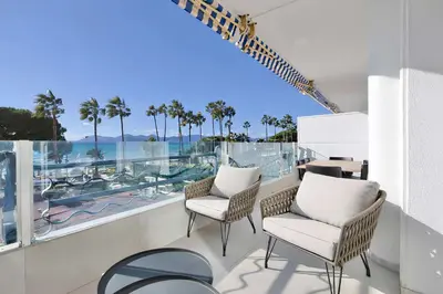 a balcony with chairs and a view of the ocean at Reflet Croisette - Luxury Apartment with Terrace and Sea View in Cannes