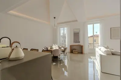 a kitchen with a long wooden table and chairs at Cannes Centre - Palais a pied - Appartement Prestige 3 chambres et studio - 8 pers in Cannes