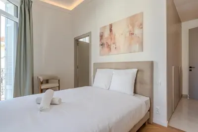 a bedroom with a large white bed with two towels on it at Cannes Centre - Palais a pied - Appartement Prestige 3 chambres et studio - 8 pers in Cannes