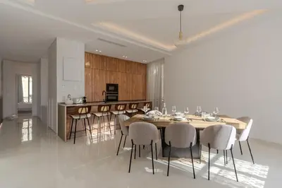 a kitchen and dining room with a table and chairs at Cannes Centre - Palais a pied - Appartement Prestige 3 chambres et studio - 8 pers in Cannes
