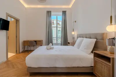 a kitchen with a bar with stools at Cannes Centre - Palais a pied - Appartement Prestige 3 chambres et studio - 8 pers in Cannes