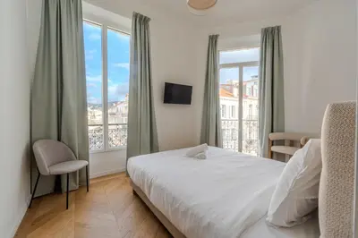 a white bathroom with a tub and a sink at Cannes Centre - Palais a pied - Appartement Prestige 3 chambres et studio - 8 pers in Cannes