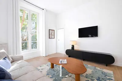 a living room with a couch and a table at Les Lucioles 2 - Appartement Luxe Studio Balcon in Cannes