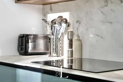 a kitchen counter with a microwave and some utensils at Les Lucioles 2 - Appartement Luxe Studio Balcon in Cannes