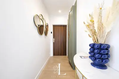 a hallway with a blue vase on a counter at Les Lucioles 2 - Appartement Luxe Studio Balcon in Cannes
