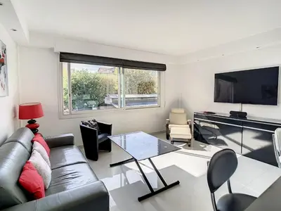 a living room with a couch and a tv at Luxueux appartements idéalement situés en plein centre ville de Cannes in Cannes