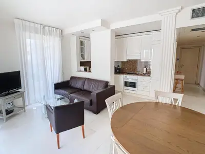a living room with a couch and a table at Appartements Medicis in Cannes
