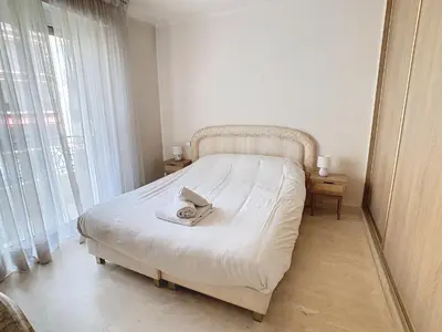 a bedroom with a bed with a towel on it at Appartements Medicis in Cannes