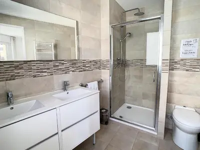 a bathroom with a sink and a shower and a toilet at Appartements Medicis in Cannes