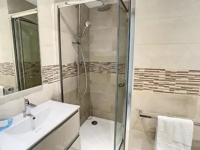 a bathroom with a shower and a sink at Appartements Medicis in Cannes