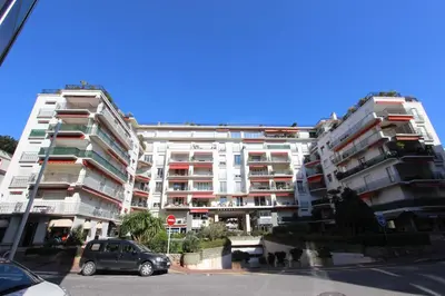 a large apartment building with a car parked in front at Appartements Cannes Centre : Rond Point Duboys d'Angers in Cannes