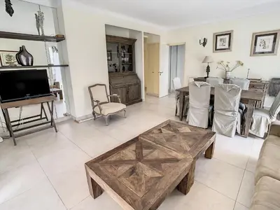 a living room with a couch and a table at Appartements Cannes Centre : Rond Point Duboys d'Angers in Cannes