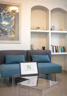 a living room with a couch and a laptop on a glass table at Cannes Marina by Connexion in Cannes