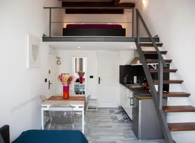 a small room with a loft bed and a table at Sweet Holiday in Cannes