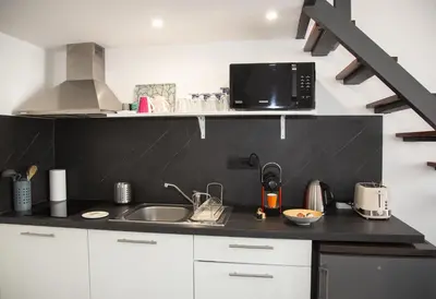 a kitchen with a sink and a microwave at Sweet Holiday in Cannes