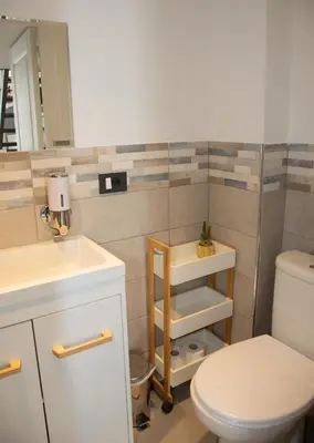 a bathroom with a toilet and a sink and a mirror at Sweet Holiday in Cannes