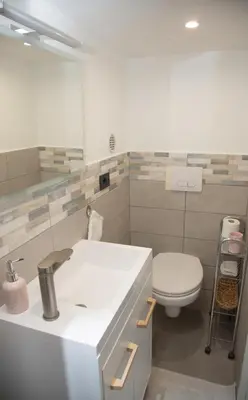 a bathroom with a white sink and a toilet at Sweet Holiday in Cannes
