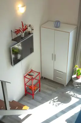 a room with a white cabinet and a red shelf at Sweet Holiday in Cannes