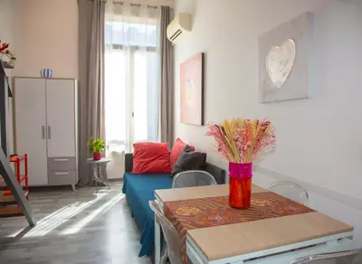 a living room with a blue couch and a table at Sweet Holiday in Cannes