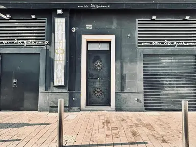 a black building with a door and two garage at Croisette Studio 1 min beach in Cannes