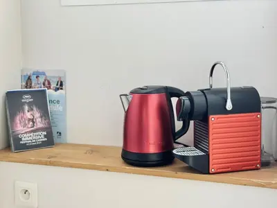 a red and black coffee maker on a shelf at Croisette Studio 1 min beach in Cannes